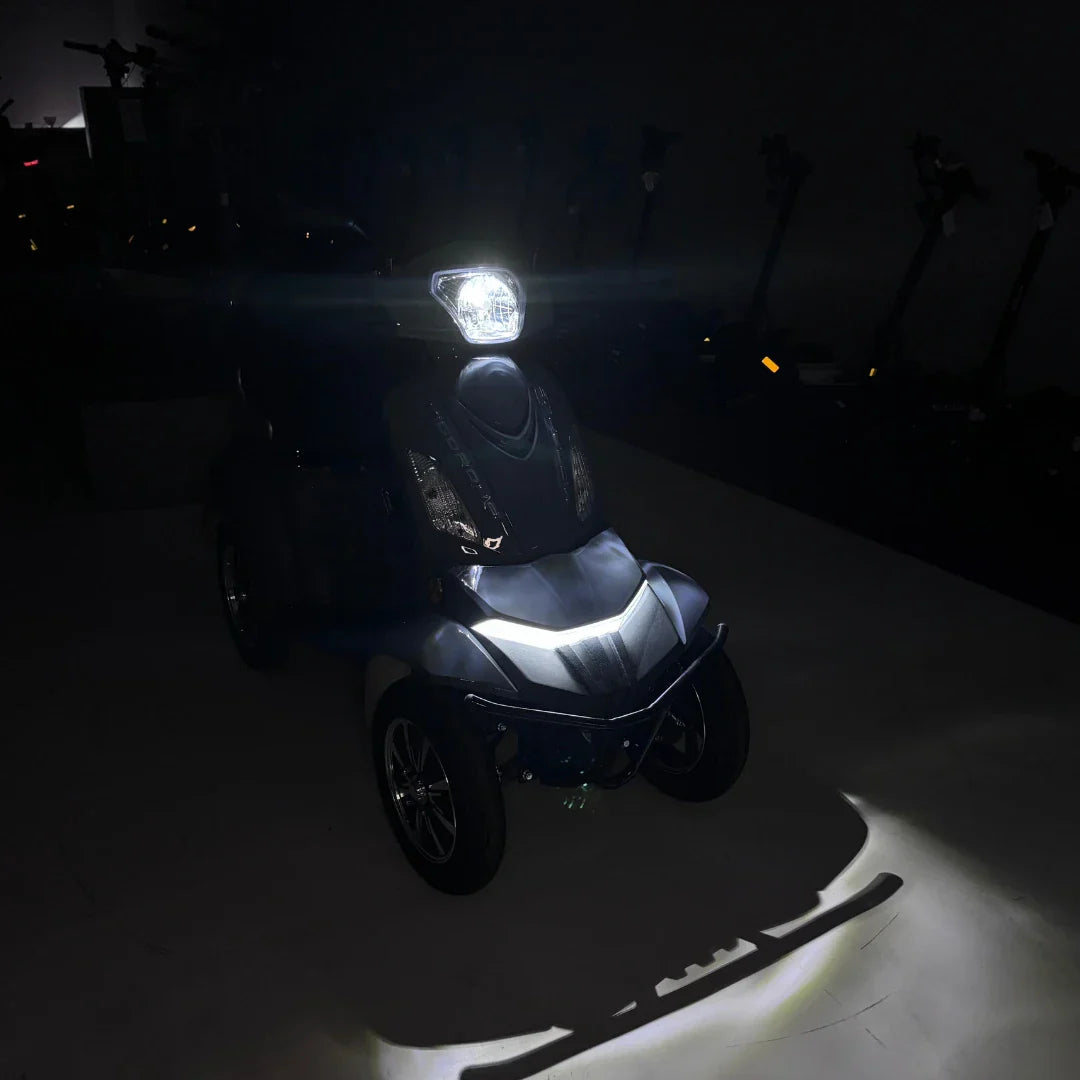Vigorous VISTA Q1 – front three-quarter view with lights on at night