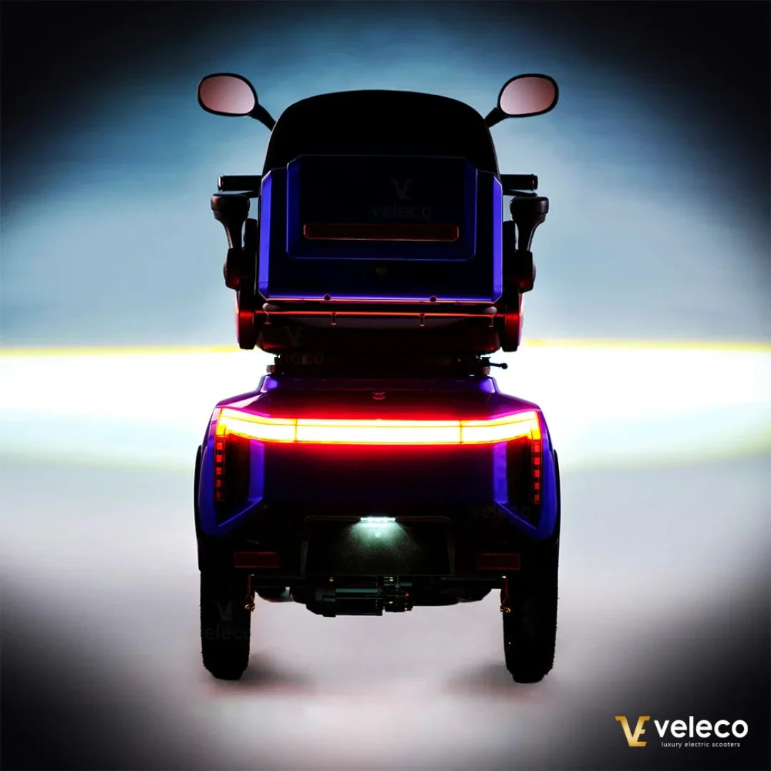 Electric Mobility Scooter Veleco Gravis features a sleek design with vibrant lighting, enhancing visibility.