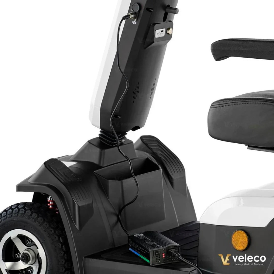 Electric Mobility Scooter Veleco Sharpy features a sleek design with a comfortable seat and a functional charging setup.