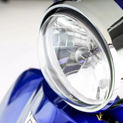 Electric Mobility Scooter Veleco Zt15, featuring a close-up of the stylish headlight design and chrome detailing.