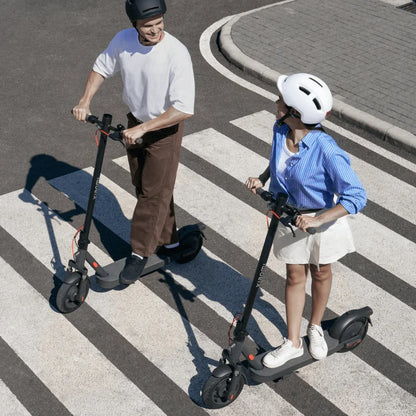 Electric Scooter Xiaomi Elite, featuring two riders on scooters, crossing a pedestrian zone, urban setting.
