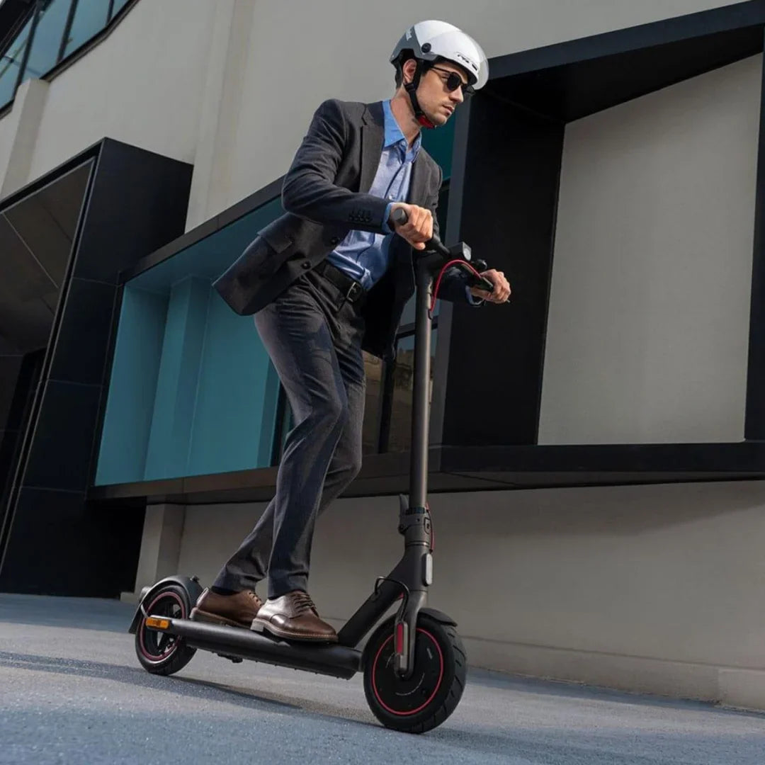 Electric Scooter Xiaomi 4 Eu, stylish and modern design, a user in a suit riding on smooth pavement.