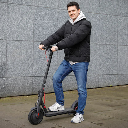 Electric Scooter Xiaomi 4 Eu, sleek black design, young man riding, urban setting, perfect for commuting.