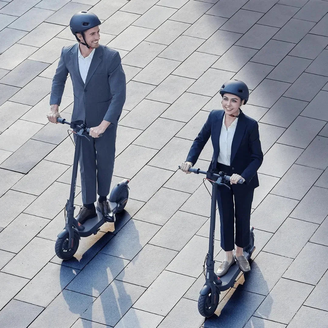 Electric Scooter Xiaomi 4 Pro 2nd Gen, stylish individuals riding scooters on a trendy paved surface.