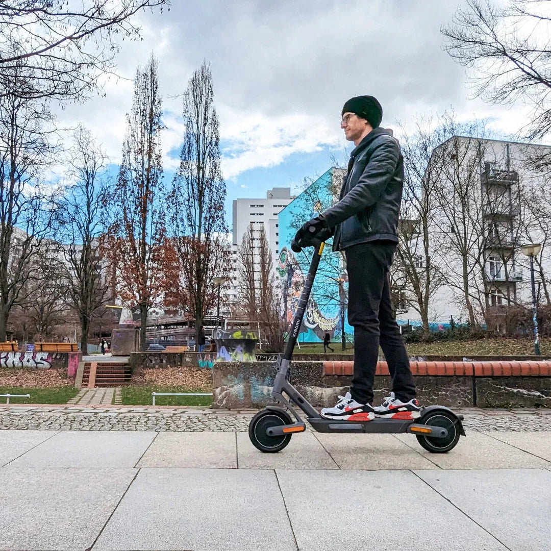 Electric Scooter Xiaomi 4 Ultra, sleek design, rider in urban setting, ideal for commuting and leisure.