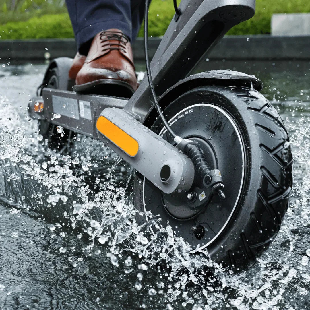Electric Scooter Xiaomi 4 Ultra, showcasing a sleek design as it glides through water, creating splashes.