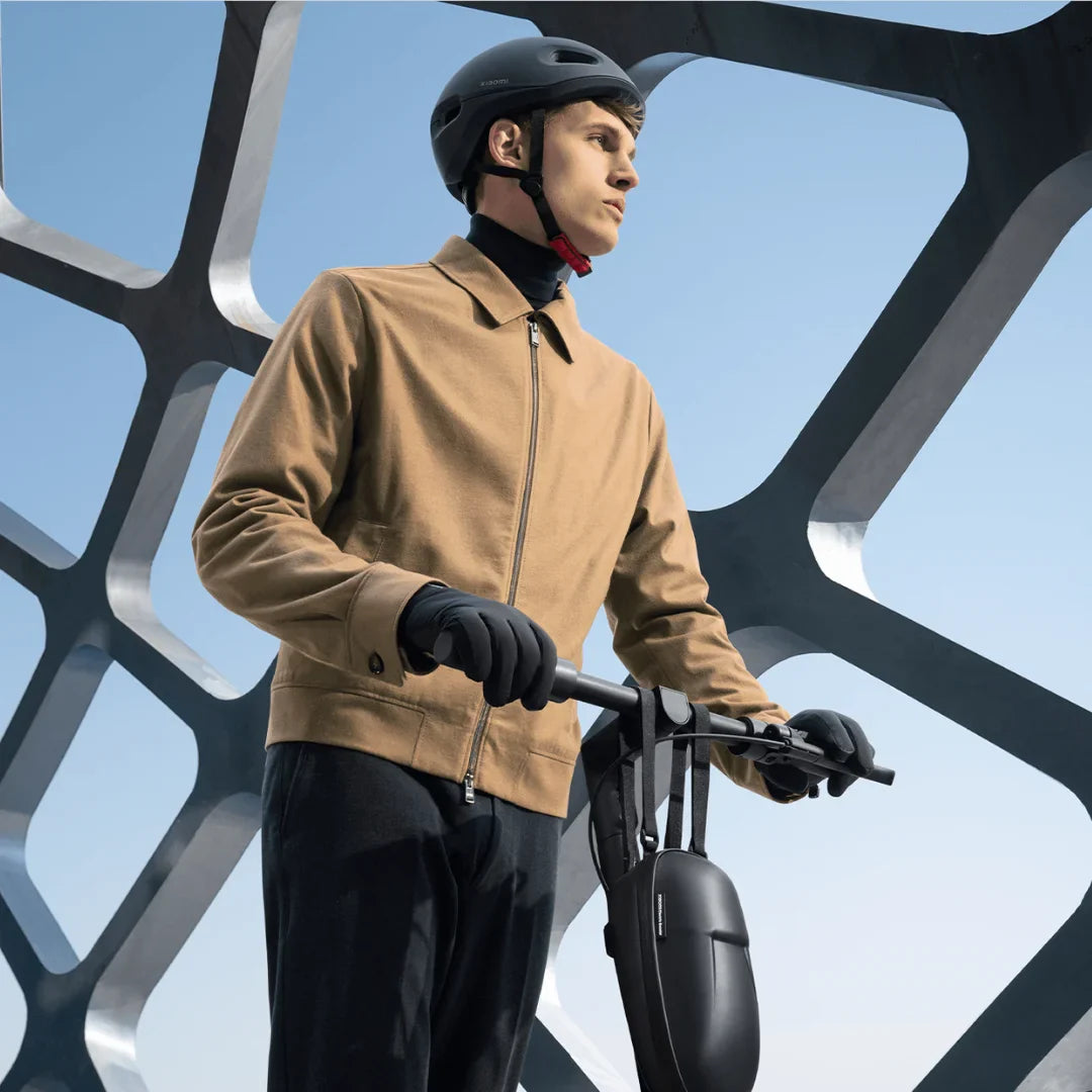 Electric Scooter Xiaomi 4 Ultra, sleek design, rider in stylish attire, set against modern architecture.