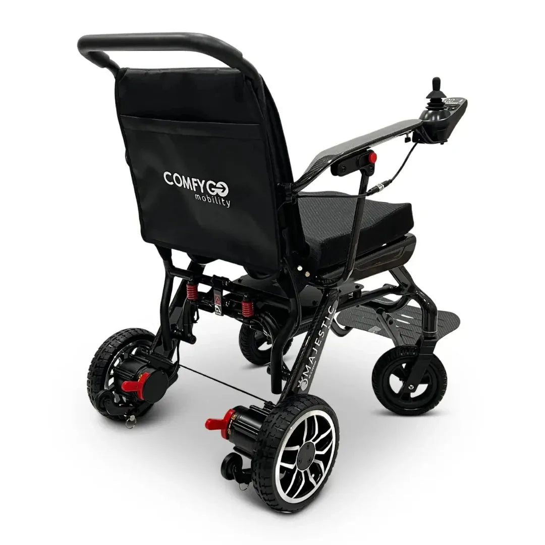 Electric wheelchair ComfyGO IQ-Carbon – rear quarter view, unfolded, showing joystick and rear wheel detail