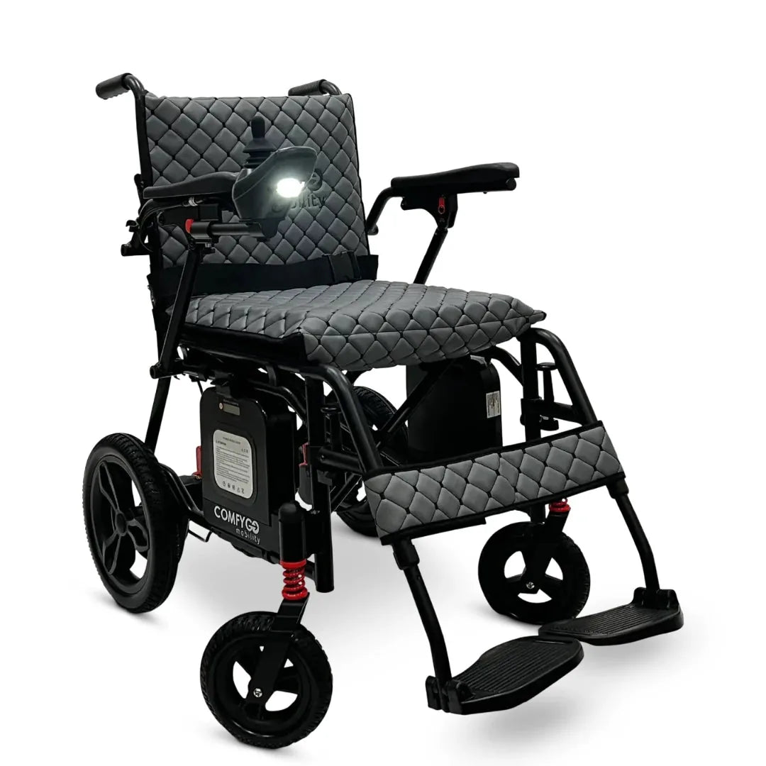 Electric wheelchair ComfyGO X7 – front three-quarter view, unfolded, with gray quilted seat and headlamp on