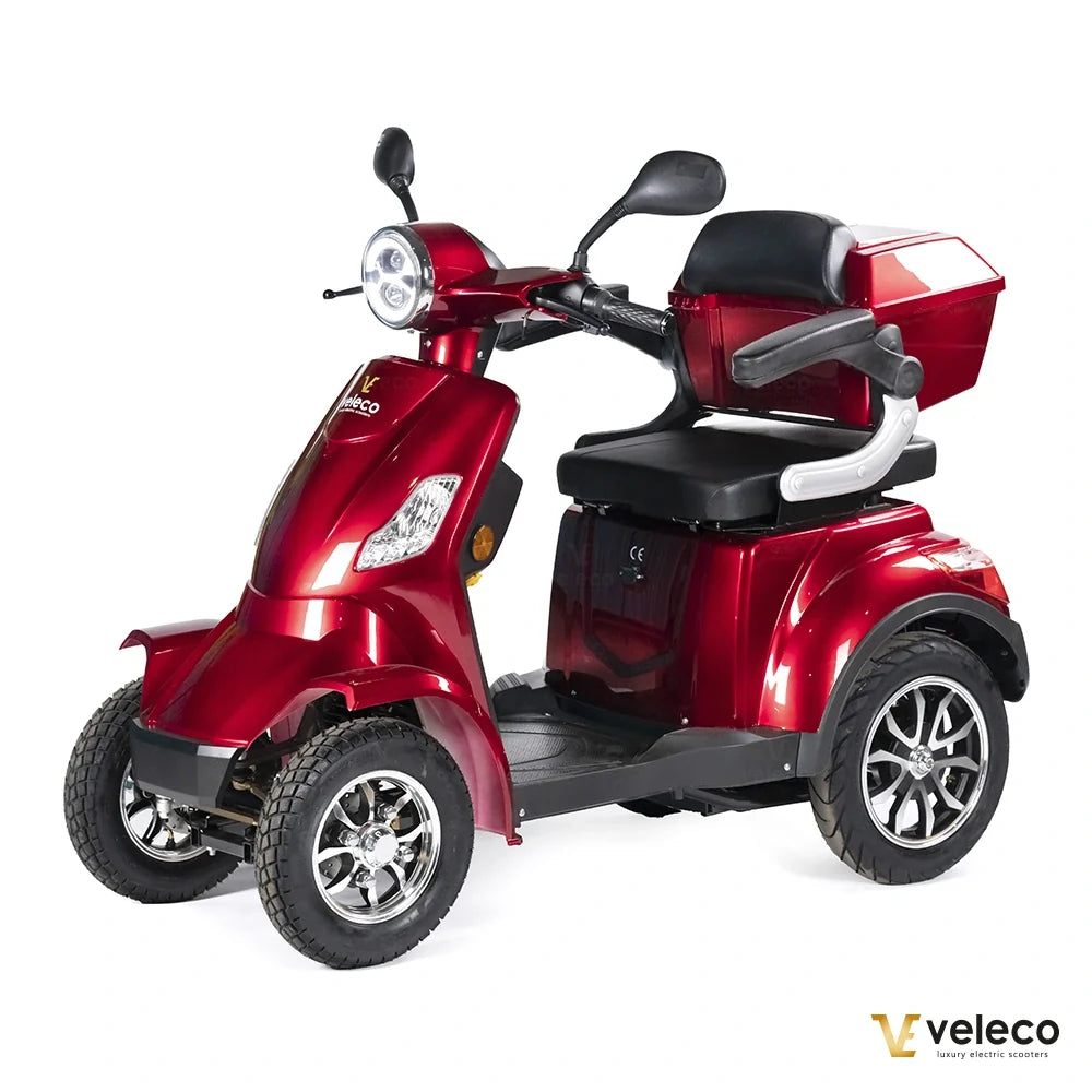 Veleco Faster – red four-wheel scooter with rear storage box