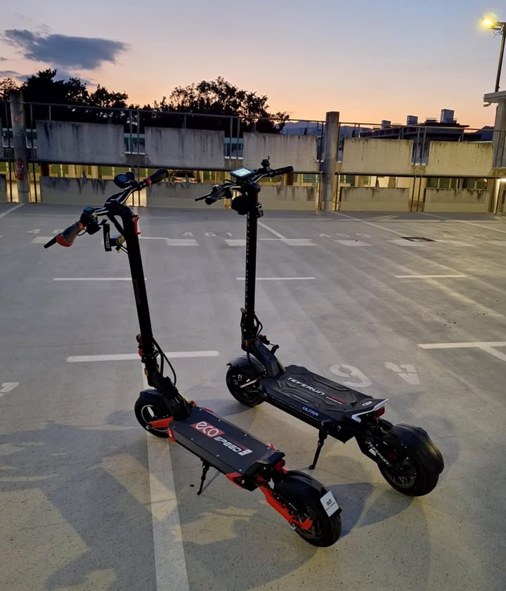 Electric scooter Teverun Fighter SUPREME 7260 Ultra 2026 – two scooters in parking garage at dusk