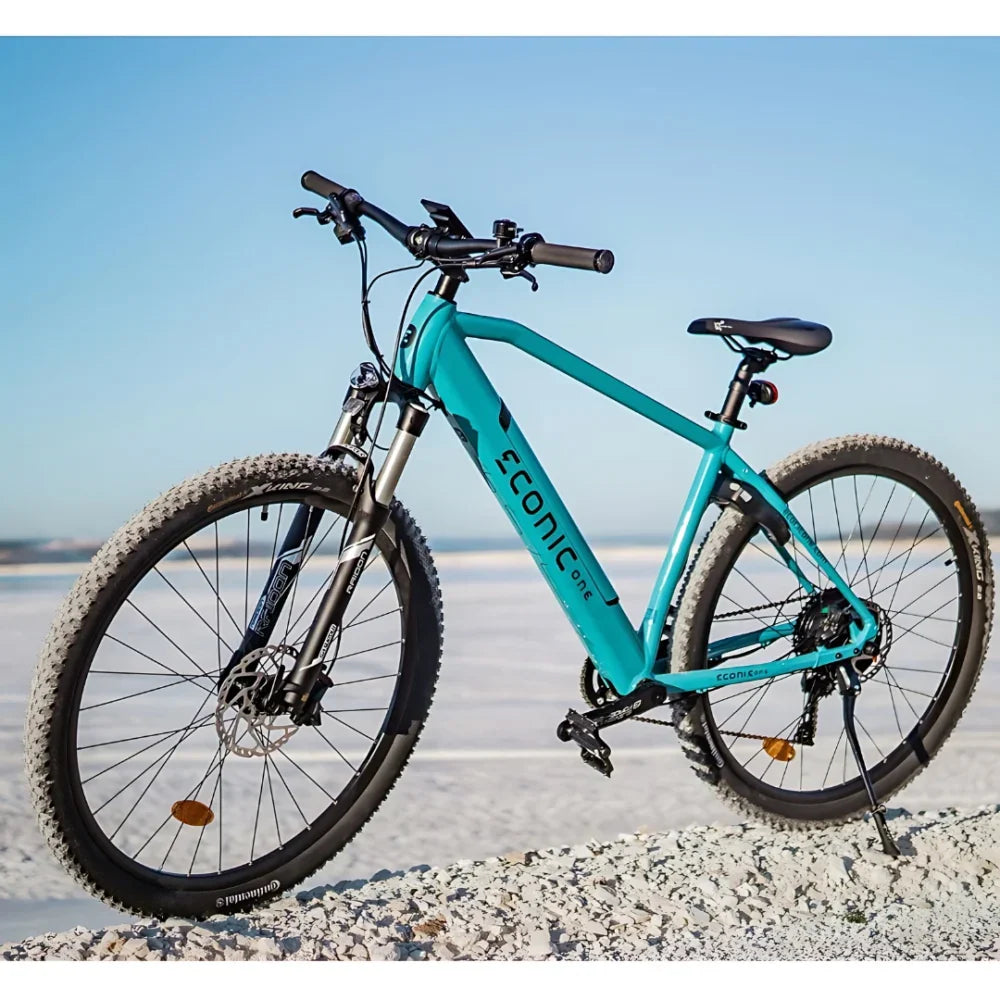 Electric Bike Econic One Cross Country features a sleek turquoise frame, rugged tires for diverse terrains, ideal for outdoor adventures.